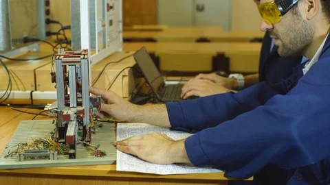 Young engineers working in the laboratory and using a computer Stock Footage 70799470
