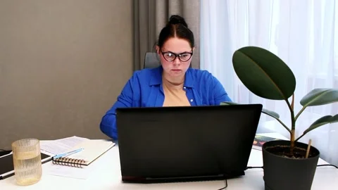 Young entrepreneur developing startup business plan at home. Determined woman Stock Footage 326197242