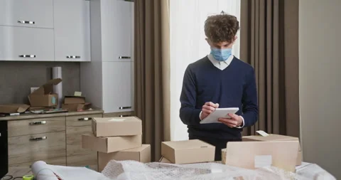 Young Entrepreneur Inspecting Parcels Before Dispatch in Home Office Video stock 267304147