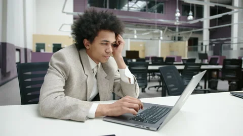 Young entrepreneur looking tired while working in modern office Stock Footage 237559840