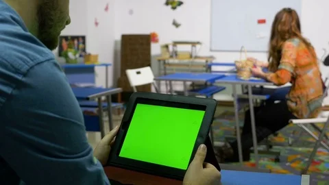 Young entrepreneur man using tablet pc with green screen in a training room Stock Footage 74429394