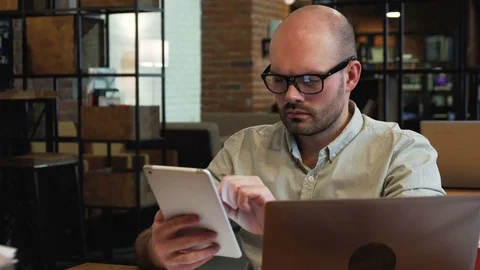 Young entrepreneur or freelancer with PC tablet in office Stock Footage 73047520