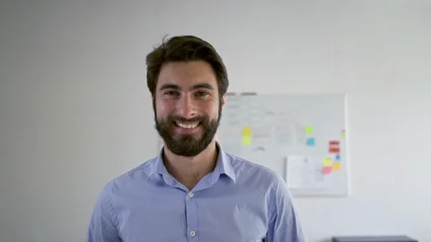 Young entrepreneur smiling at camera while standing in office Stock Footage 109338065