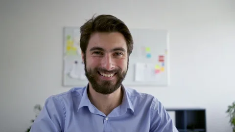 Young entrepreneur smiling at camera while sitting in office Stock Footage 109338407