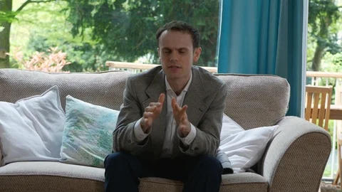 Young Entrepreneur Talking to Camera explaining his new business Idea Stock Footage 89922727