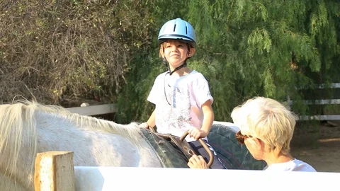 Young equestrian girl learning techniques Stock Footage 98218765