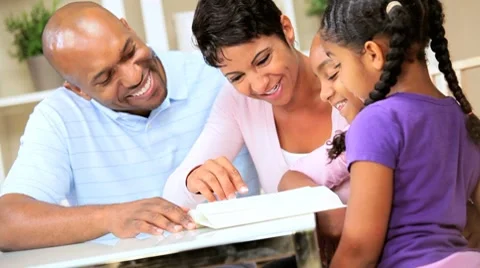 Young Ethnic Child Reading Aloud to Family Stock Footage