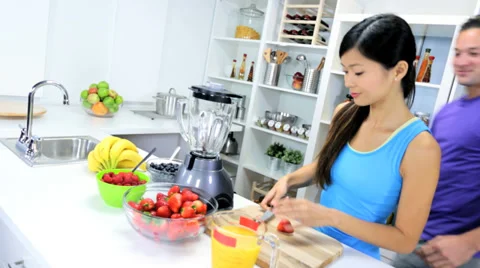 Young Ethnic Couple Using Blender Organic Fruit Drink Stock Footage