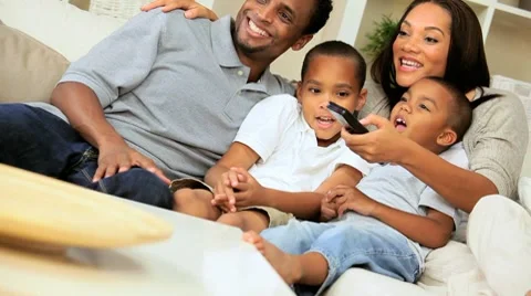 Young Ethnic Family Watching TV Together Stock Footage