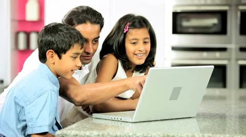 Young Ethnic Father &amp; Children Using Laptop in Kitchen Stock Footage 8764412