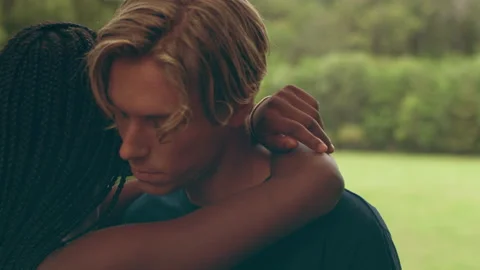 Young ethnically diverse couple hug and hold hands in the country with fields an Video stock 199458594