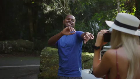 Young ethnically diverse couple playfully photograph oneanother and refuse to po Stock Footage 199461590