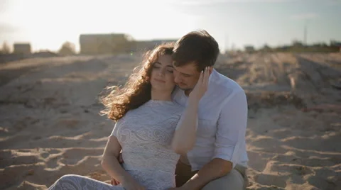 Young european couple sit on the sand Stock Footage 63131253