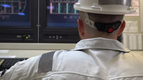 Young european engineer monitors the operation of the power station Stock Footage 119986730