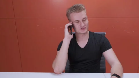 Young European Man Working Using Smartphone, Talking to Friends and Clients Stock Footage 141664231