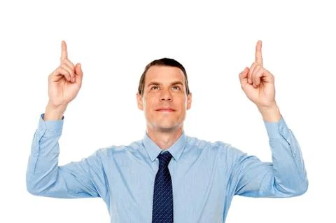 Young executive indicating and looking upwards Stock Photos