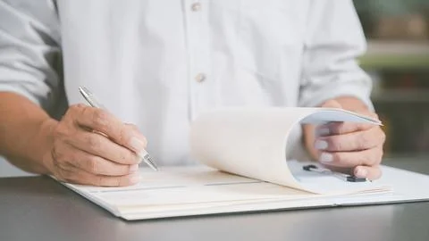 Young executives are signing documents for business contracts. Transaction .. Stock Photos
