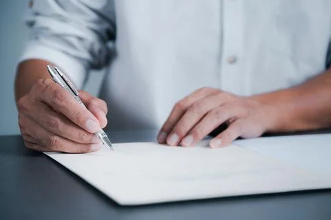 Young executives are signing documents for business contracts. Transaction .. Stock Photos