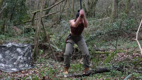 Young Explorer Chopping Wood in the Forest with axe in 4K Stock Footage 265768708