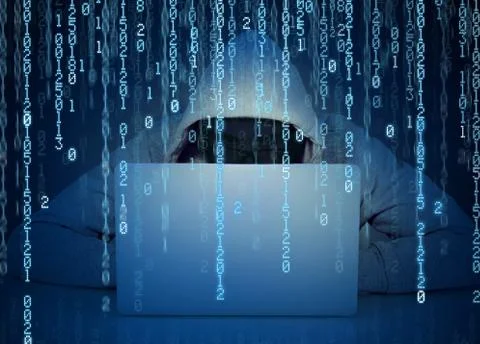 Young faceless man hacker working on a laptop on a binary code background 写真素材