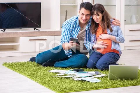 Young family in budget planning concept Stock Photos