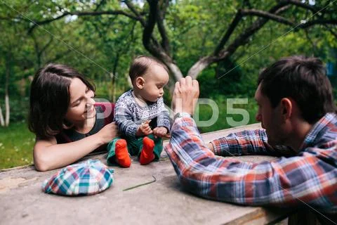 Young family with a child on the nature Stock Photos