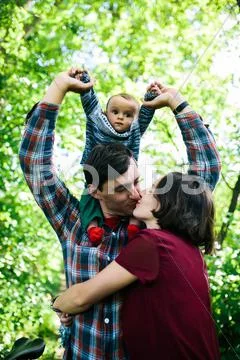 Young family with a child on the nature Stock Photos