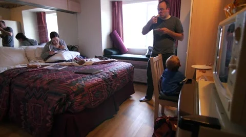 A young family eats pizza in a small hotel room Stock Footage 48377760