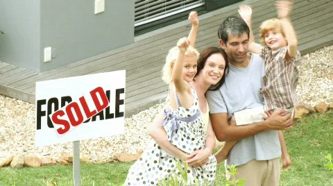 Young family in front of their new house Stock Footage