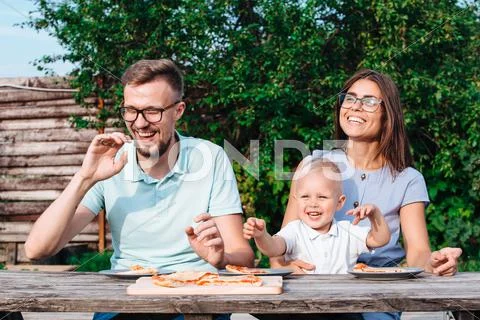 Young family have fun and dinner in the garden Stock Photos