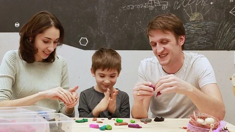 A young family having fun making plasticine Vidéo 102234580