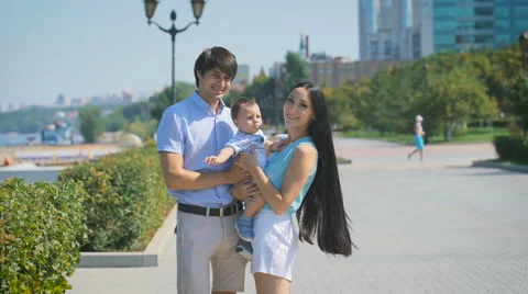 Young family looking at the camera while standing on the alley Video stock 68751591