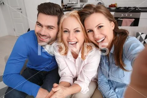 Young family with mother-in-law at home weekend taking selfie pictures top view Stock Photos