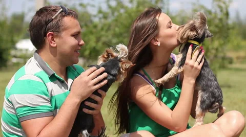 Young family relaxing with dogs on holiday Stock Footage