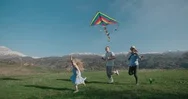 Young Family Running In The Mountains, Flying Kite In Slow Motion, Happy Family Stock Footage