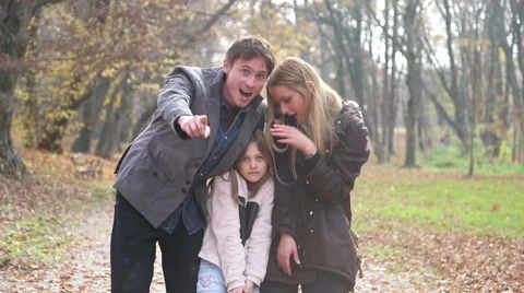 Young family waving at camera in the park Stock Footage 59553732