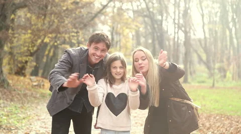 Young family waving at camera in the park Stock Footage 59553737