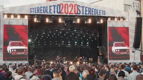 Young fans dance in front of the stage, enjoying music at the Stereoleto Summer Stock Footage 167364222