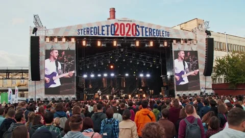 Young fans dance in front of the stage, enjoying music at the Stereoleto Summer Stock Footage 167364458