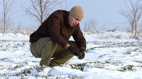 Young farmer checking on wheat in winter Stock Footage 49103222