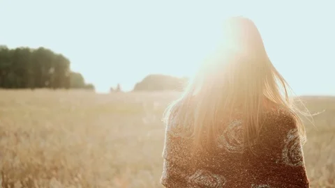 Young farmer girl walking through wheat field at Sunset. Modern farming Stock Footage 119354853