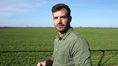 Young farmer walking in wheat field and examining crop. Stock Footage 122504141