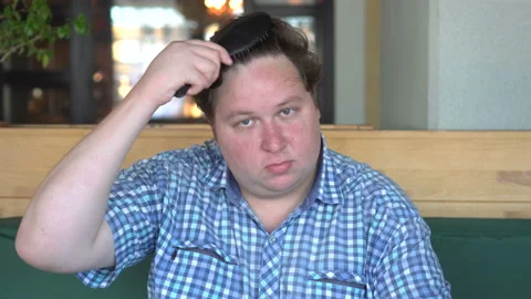 Young fat man comb his hair. handsome man cares for himself Stock Footage 95431985