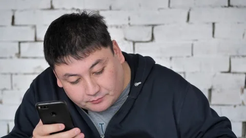 A young fat person eats a Burger 스톡 동영상 125827811