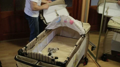 Young father assembling a cradle Stock Footage 67312732
