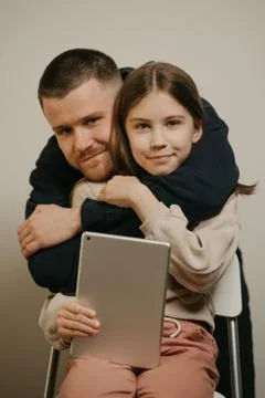A young father with a beard posing with her daughter. Family photo. Stock Photos