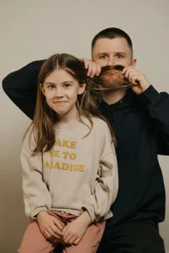 A young father with a beard posing with her daughter. Family photo. Stock Photos