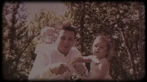 The young father blows soap bubbles with his daughter and son Видео 104559534