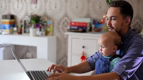 Young Father with a Child Working on a Computer Stock Footage 52159064