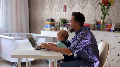 Young Father with a Child Working on a Computer Video stock 52159074
